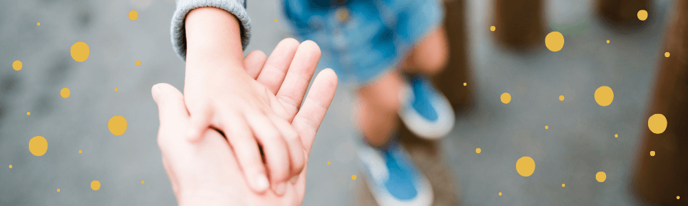 child's hand reaching parent's hand